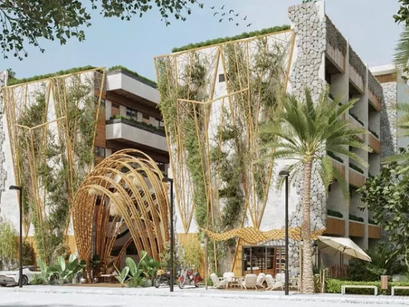 Residential building facade with a coffee shop downstairs and main entrance at Ocean Condos Tulum