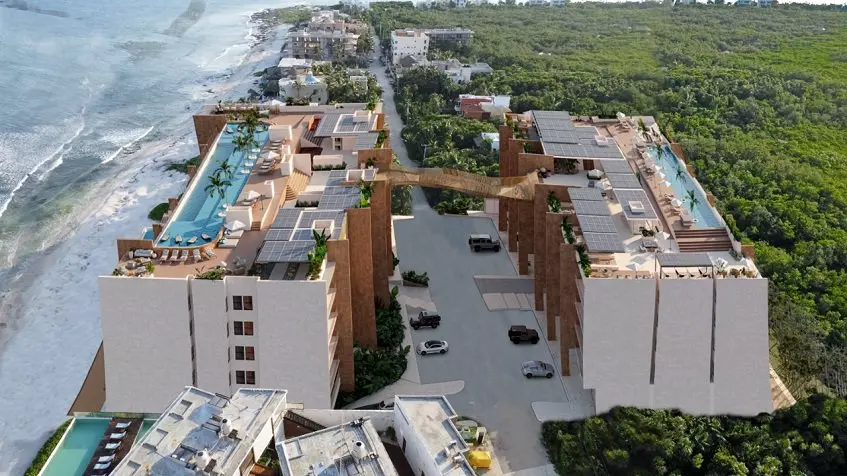 Two residential buildings with a bridge between by the ocean at Tulum Bay Tankah