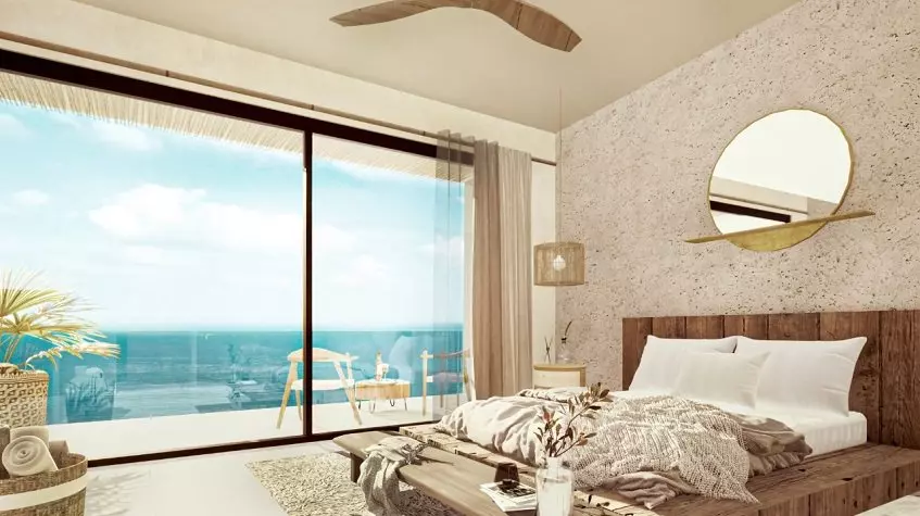 Bedroom with a wall size window, terrace ocean view at Tulum Bay Tankah