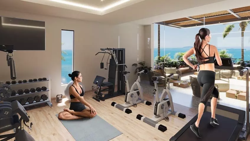 Gym and two women doing exercise, ocean view at Athimar Cozumel