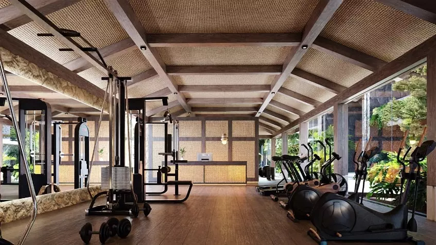 Gym with treadmills and other tools and reception at Brahma Tulum