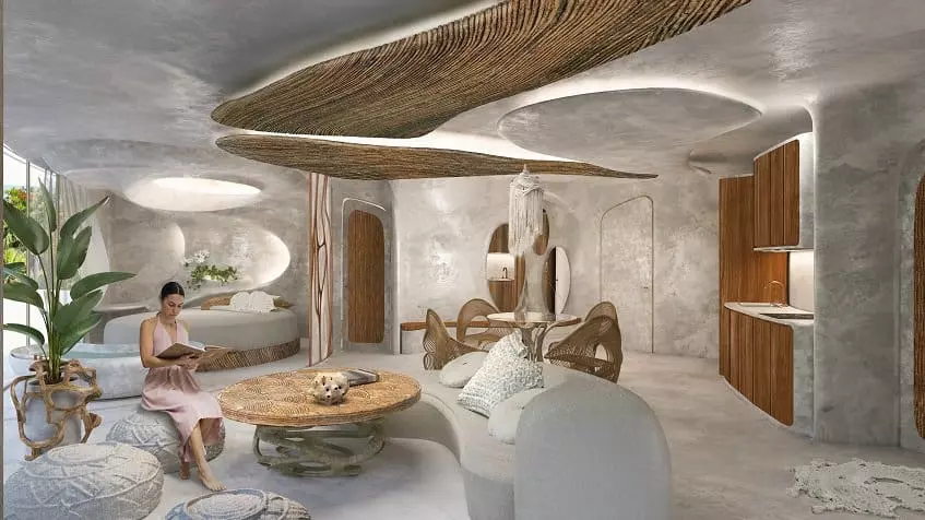 Living area and a woman sitting and reading by the coffee table at Azulik Residences Tulum