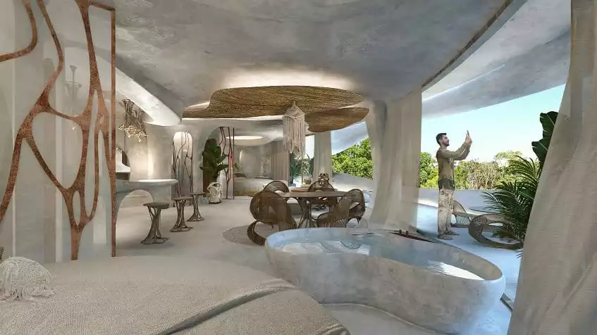 Living area and bathtub next to a dining table, man taking a picture on the terrace at Azulik Residences Tulum