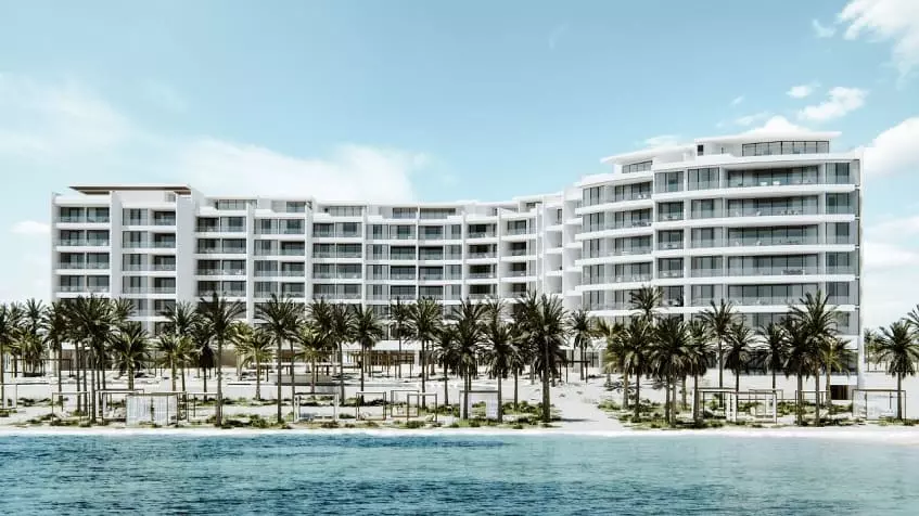 Building facade with palm trees and beach in Acanta Telchac Puerto