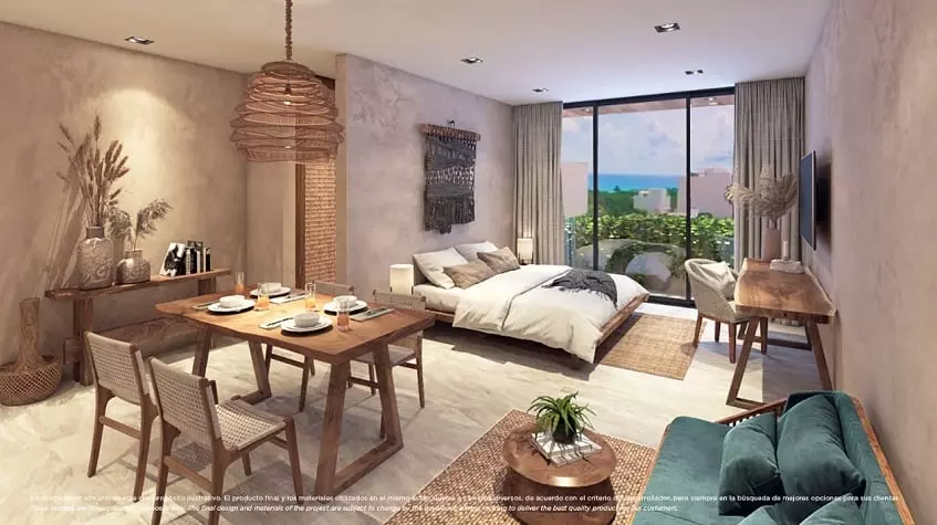 A dining room and a bedroom with ocean views at Xkaa Urban Condos