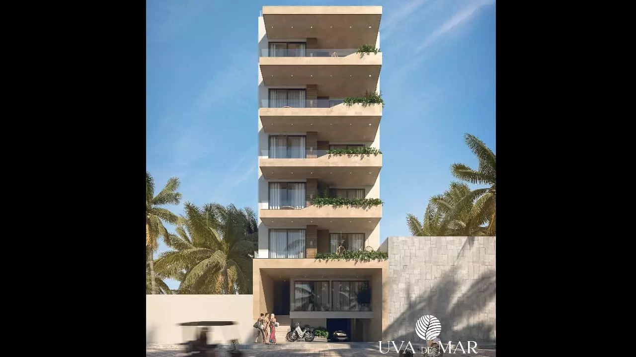 Building façade, parked bicycles and people entering Uva de Mar Puerto Morelos