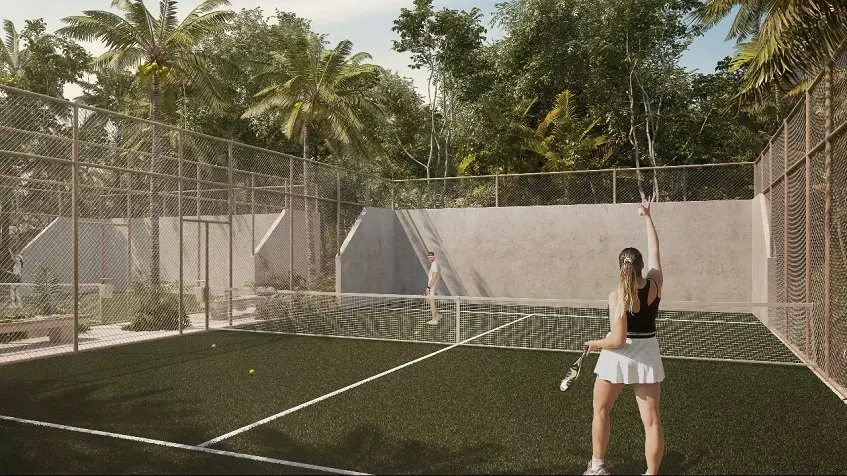 A couple playing tennis on a court in Aldea Mayab Bacalar