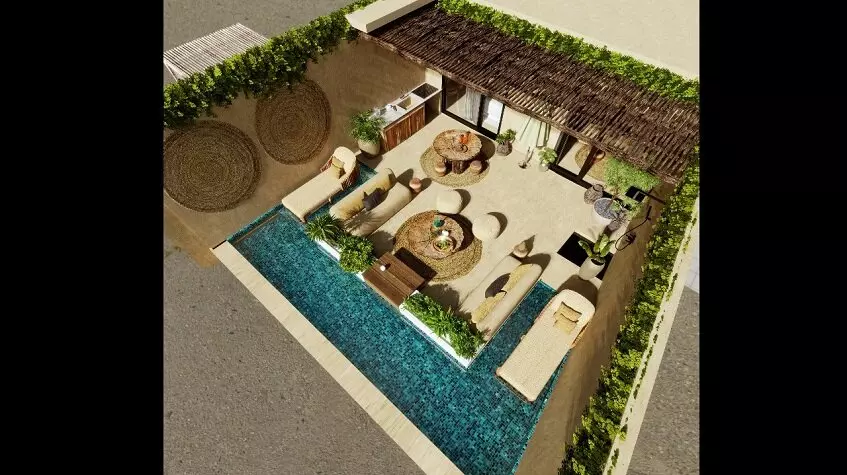 Aerial view of a terrace with pool and lounge chairs at Hunab Ku Tulum