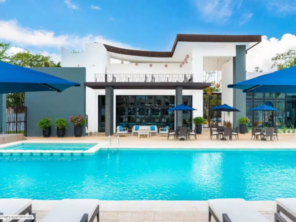 A pool with umbrellas and lounge chairs at Altaria Residencial