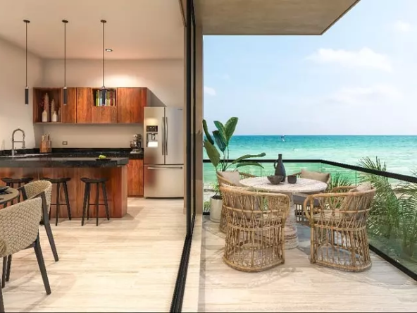 A kitchen with a balcony and a dining room with an ocean view in Bajareque Telchac
