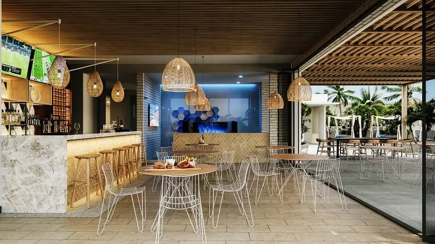 A bar and restaurant, 2 TV screens and tables in Manglar Cumbres