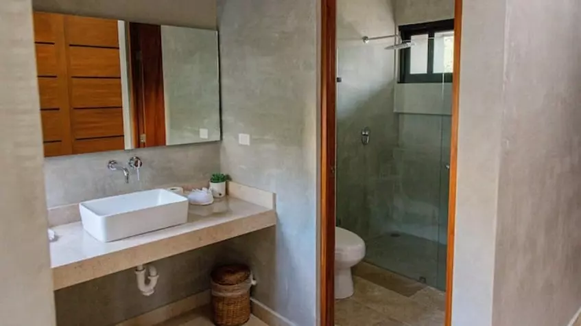 A bathroom, a sink and a shower at Villa Alquimia Tulum