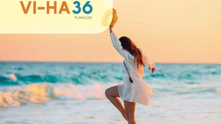 A woman dancing on the beach at Vi-ha 36 Playacar