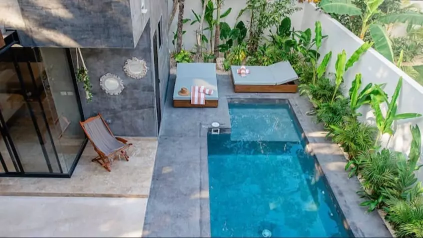 Aerial view of a pool and lounge chairs at Villa Alquimia Tulum