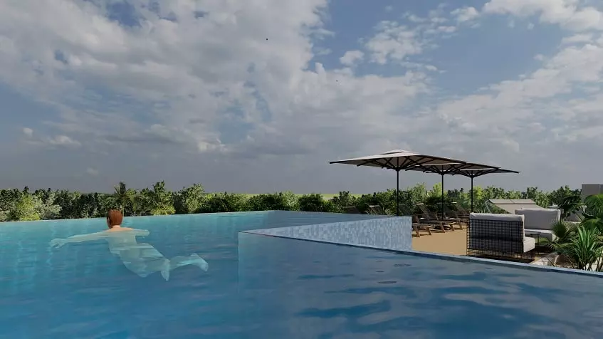A terrace with a pool, a man swimming and lounge chairs at Kiwik Tulum