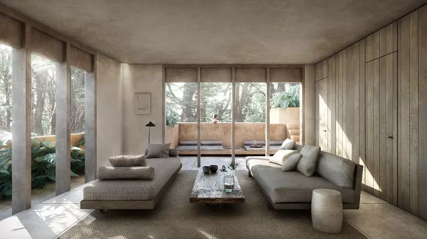 A living room with 2 sofas and a view of the garden in Candela Tulum