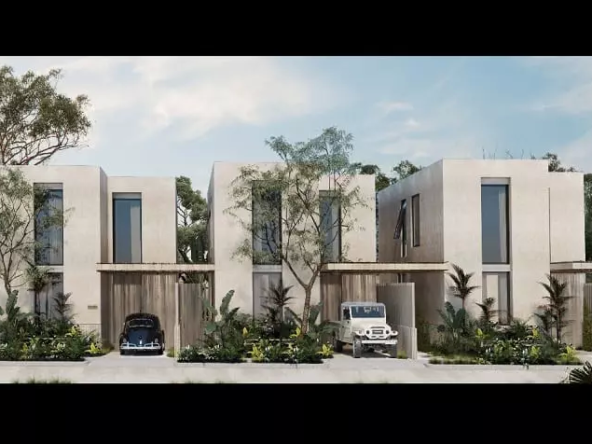 Facade of 3 houses with parked cars at Casa Aurora Tulum