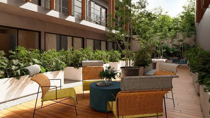 A terrace with plants, chairs and tables at Olaya Playa