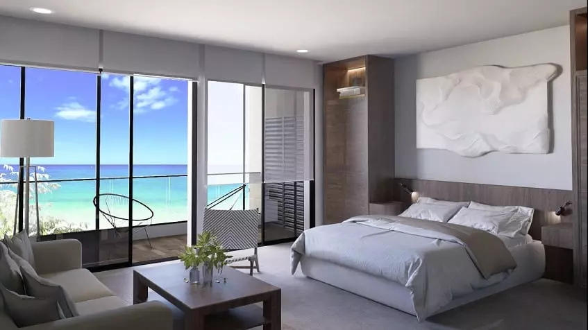 Bedroom with a balcony and ocean view at Sea Loft Cozuemel