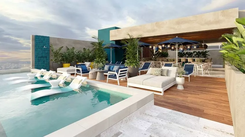 A terrace with lounge chairs and a pool at Olaya Playa