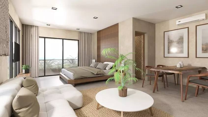 Studio interior with a bed and dining table at Xkaa Downtown Condos
