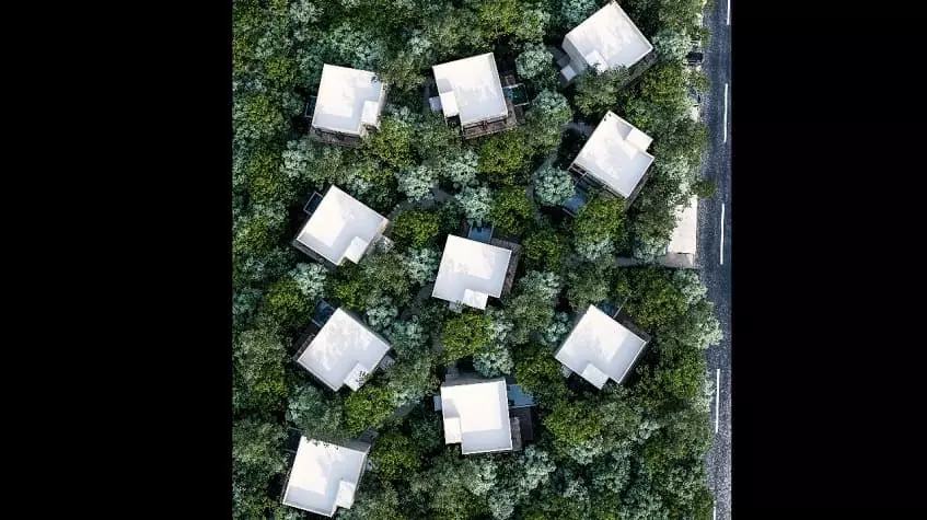 Aerial view of 10 white roofs in the jung le at Trobbu Tulum