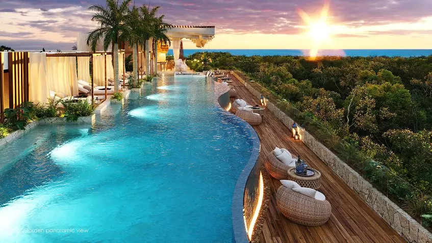 A large pool with sun loungers and lounge chairs at Nequen del Mar Tulum