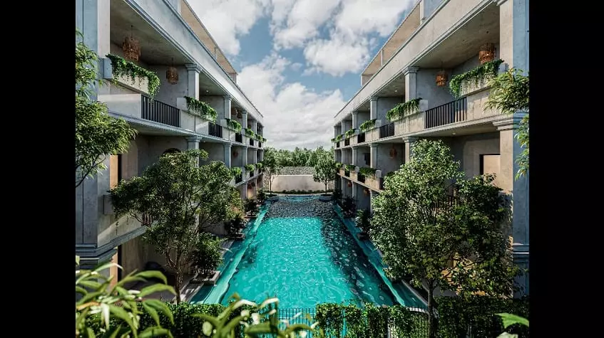 Two building facades and a pool in the middle at Core Tulum