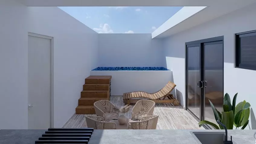 Pool terrace with a small table, surrounded by a white wall at Edzna Tulum