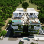 Aerial view of new building, solar panels, several trees at Arvore Cancun