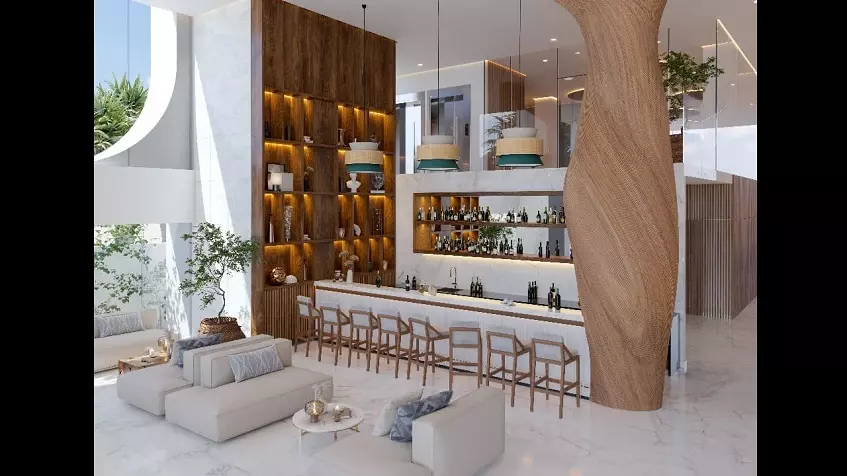 A bar area with several bottles of liquor, large wooden furniture and sofas at Mara bella Cancun
