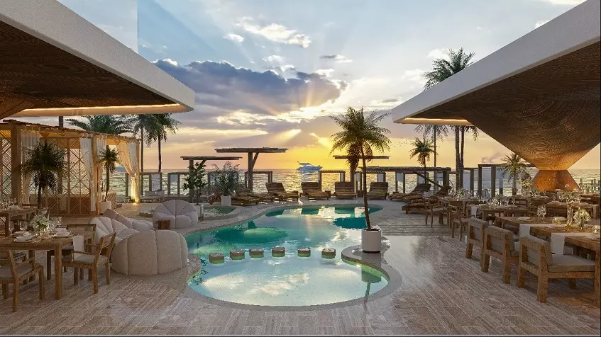 Beach club with pool in the middle, restaurant, ocean and sunset view at Mara bella Cancun