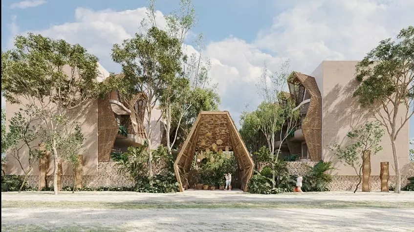 A facade of a main entrance and a couple kissing in Grand Selva Tulum