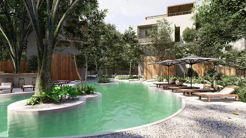 A pool with lounge chairs and gardens at Natum Reserve