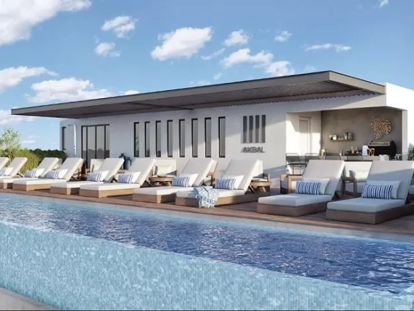 A swimming pool with lounge chairs at Akbal Playa del Carmen