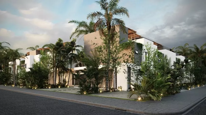 Facade of houses and palm trees in Fabula Tulum