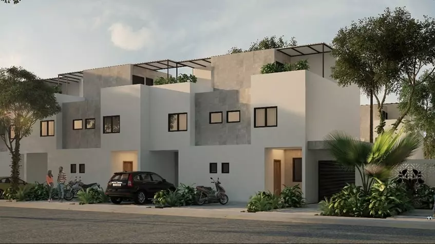 Facade of houses, a car and a motorcycle in Fabula Tulum