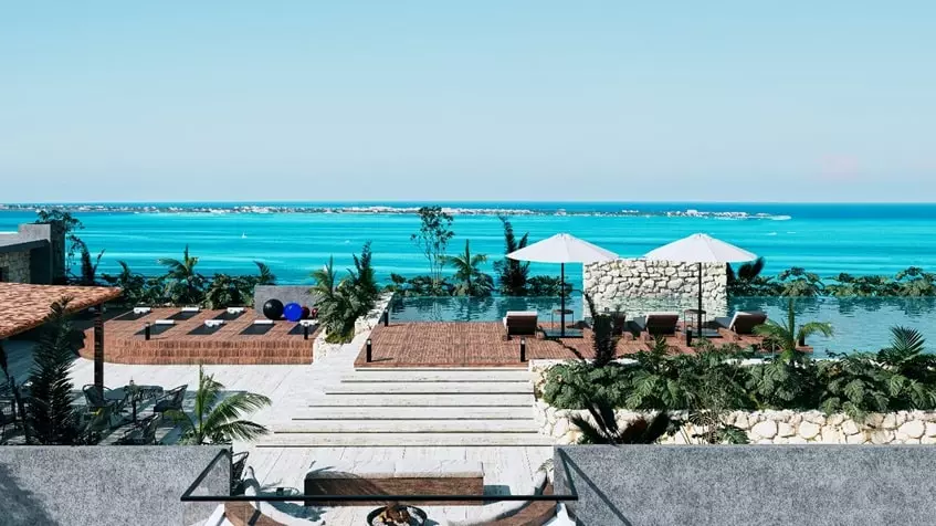 A terrace with ocean view and umbrellas at Dharana Tower Cancun