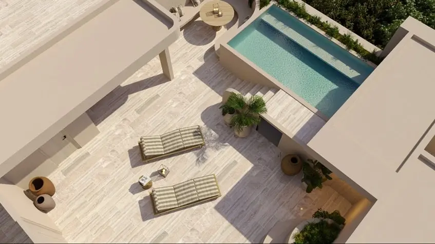 Aerial view of a pool with lounge chairs and plants in Retrit