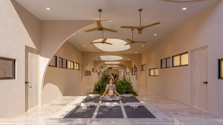 A woman sitting doing yoga in a large room in Retrit