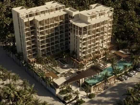 Aerial view of 2 apartment buildings and surrounding palm trees in Dorada