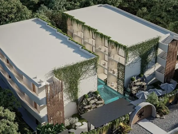 Aerial view of a new real estate development with a pool in the middle of Mizu Tulum.