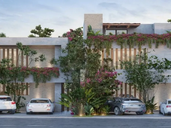 Facade of Corax Tulum Habitat with double parking spaces and cars