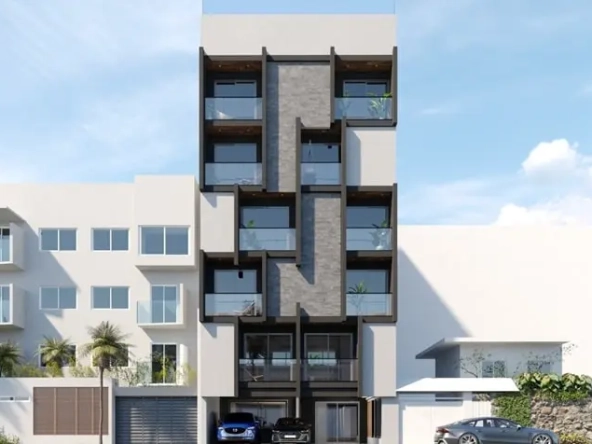 Facade of an apartment building with a parking lot below at Black Savage Playa del Carmen