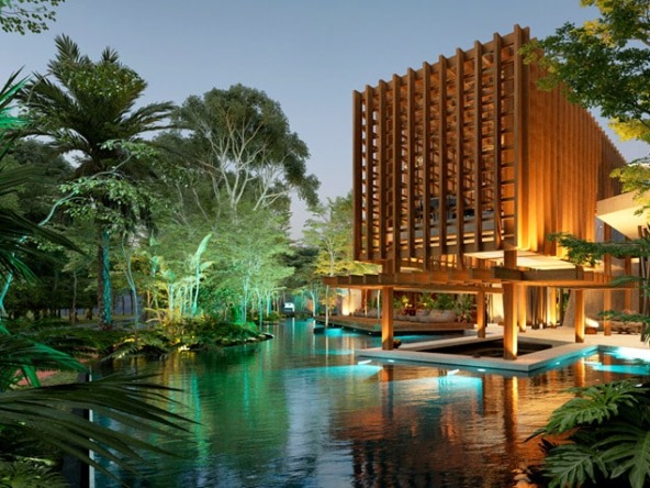 A facade of a main entrance, trees and a lagoon at Puerto 369 Puerto Morelos