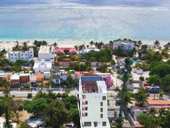 an aerial view of a building overlooking the sea in soulam puerto morelos