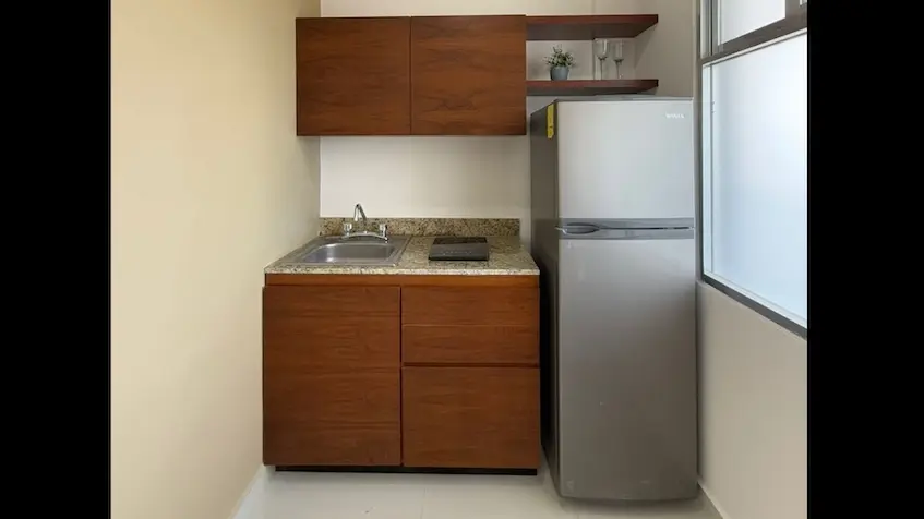 A kitchen with a sink and a refrigerator in Zentrik Tulum Estudios