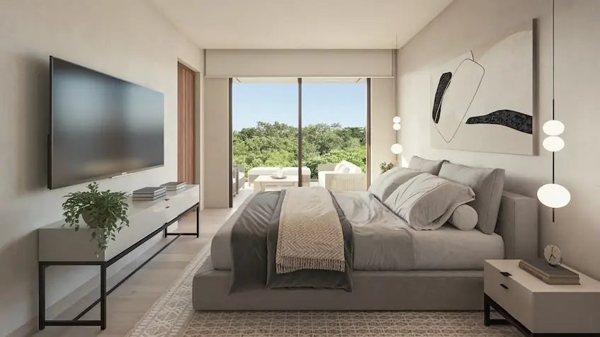 A bedroom with a large television and a large window in Oceanna Residences Playa del Carmen
