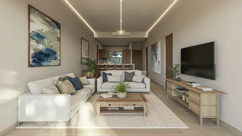 A living room with a tv and couches in Oceanna Residences Playa del Carmen