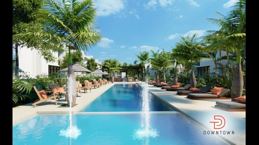 Dos albercas y solarium rodeados de palmeras en Downtown en Tulum